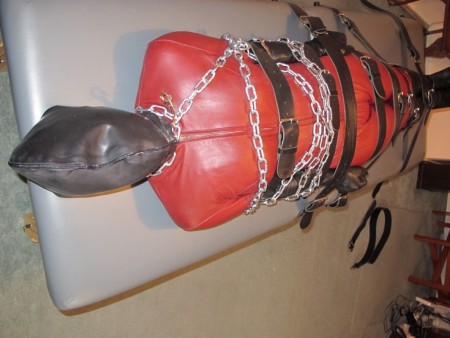 Doublerubber Hooded Catsuited Strapped To The Bondage Table