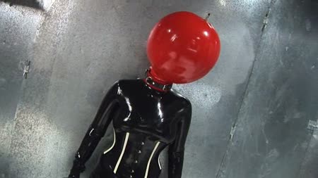 Encased In The Black Stuff - This prisoner enjoys her latex far too much she is literally dripping wet as she is encased in the black stuff. We secure her arms and legs and keep her legs open by fixing them to the spreader bar. Now we can get this rubber slut to climax for us as we fill her cunt with a dildo and masturbate her until she explodes with a huge orgasm. Once its all over she is left in her bondage and cunt filled while her next treatment is prepared.