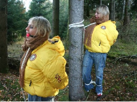 Downjacket - Miri was wearing a very heavy down jacket in the forest, having fun till a bad guy was coming and handcuffes her. Ballgagged, tied feet, blindfolded with a scarf.