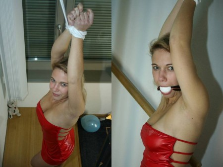 Hands Up - Hands tied up above her head, blindfolded and gagged, wearing a hot short red dress..