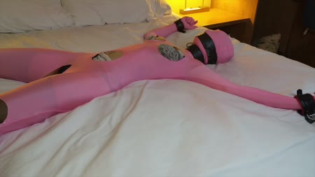 Trip Six Captured Pt 3 - In our finale, Trip Six is stuck on the bed tied spread eagle in a shiny pink zentai that happens to also be thin enough where you can see all of her lingerie and stockings underneath.. Our masked villain decides to cut the feet off of her leggings, exposing her stocking covered feet for tickling. She thrashes on the bed, but cant stop the tickling.. Next he cuts a few more hole in her zentai to expose some more sensitive areas... And then vibrates and plays with her until she has a screaming, back arching orgasm.